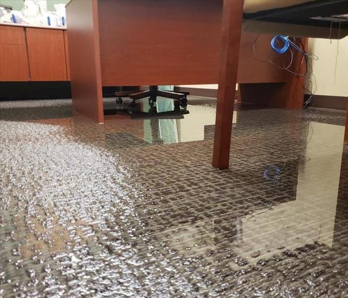 commercial carpet with water standing and desks
