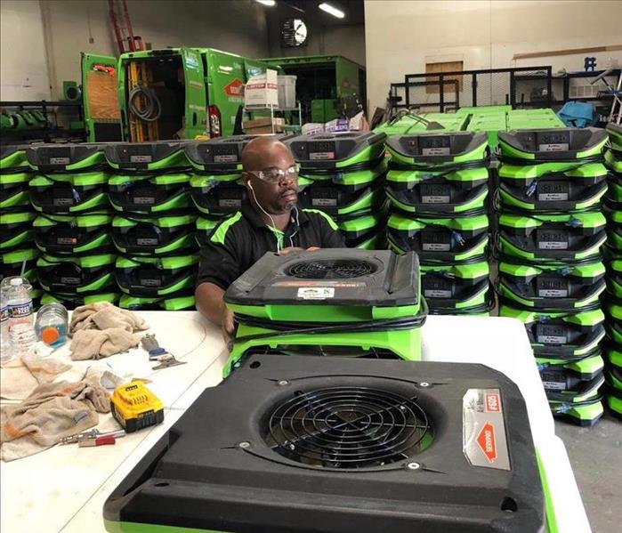 SERVPRO employee cleaning equipment 