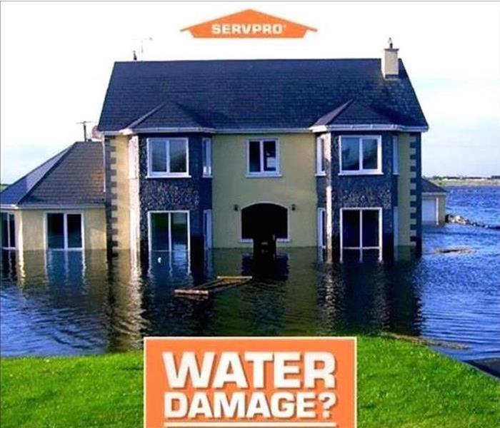 House sitting in water with SERVPRO logo
