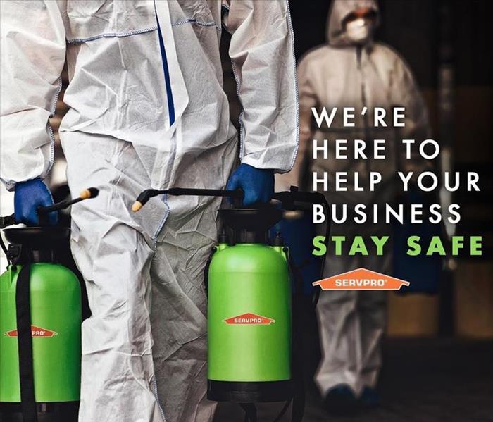 SERVPRO  employees in PPE Carrying chemicals 